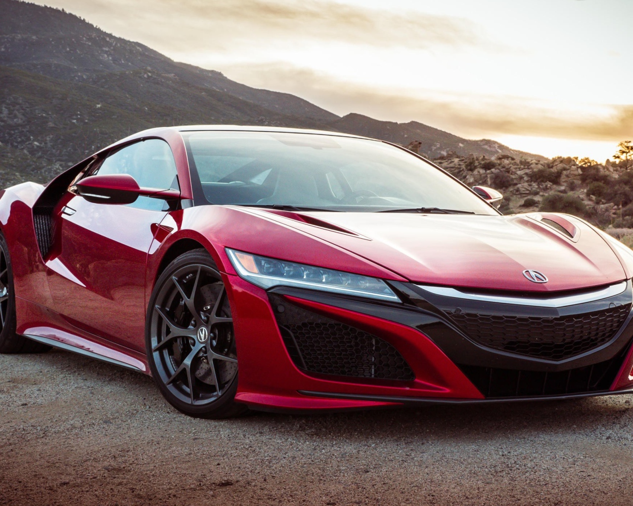 Red car Acura NSX, 2017 amid the mountains