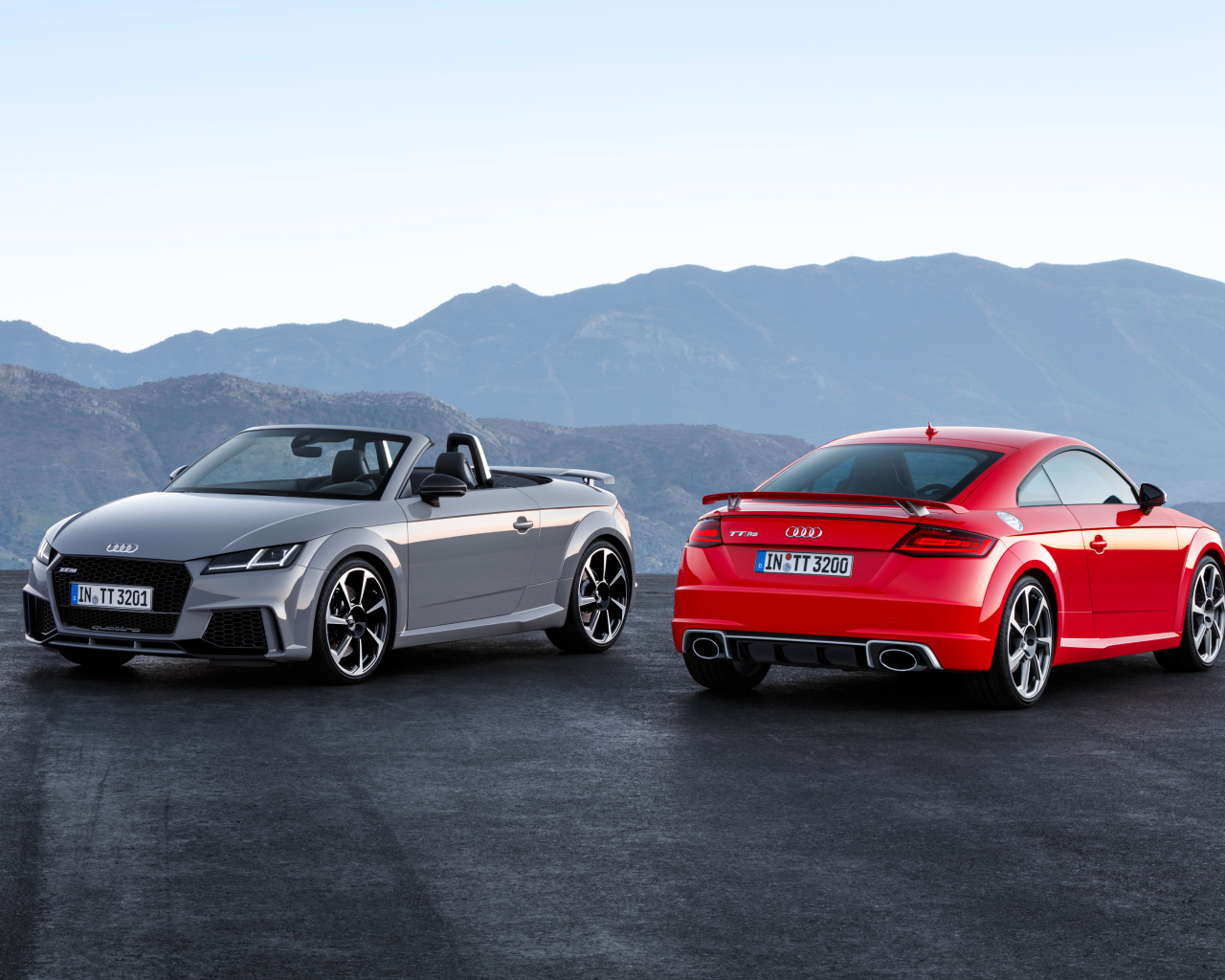 Two cars of silver Audi TT and red Audi Roadster