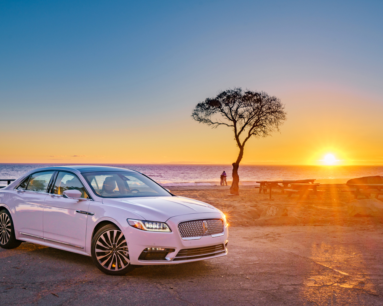 White Lincoln Continental 2017 on the background of sunset