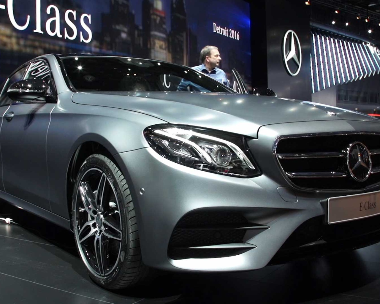 Презентация серебристого автомобиля Mercedes-Benz E-Class 2017 года 