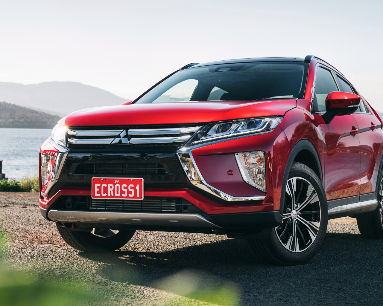 Red SUV Mitsubishi Eclipse Cross Exceed, 2018 on the background of the ocean