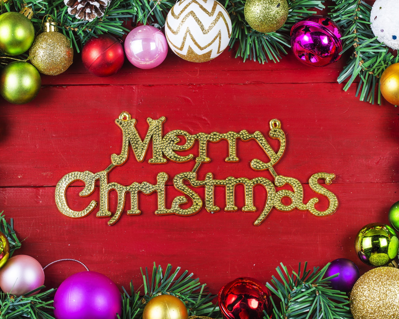 Merry Christmas inscription on a red background with Christmas-tree decorations for Christmas