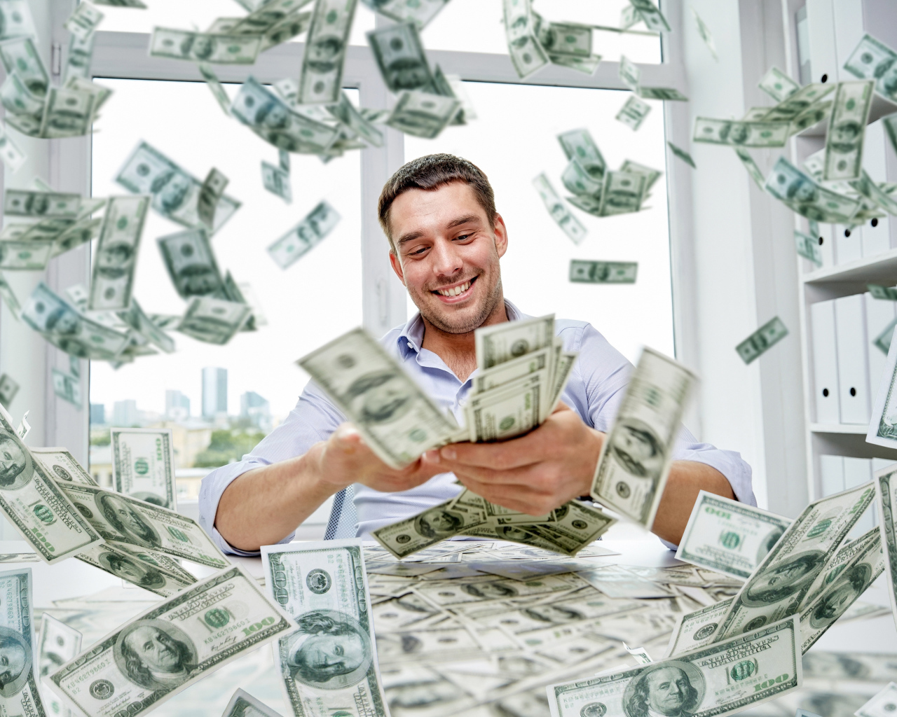 A smiling man is scattering dollars