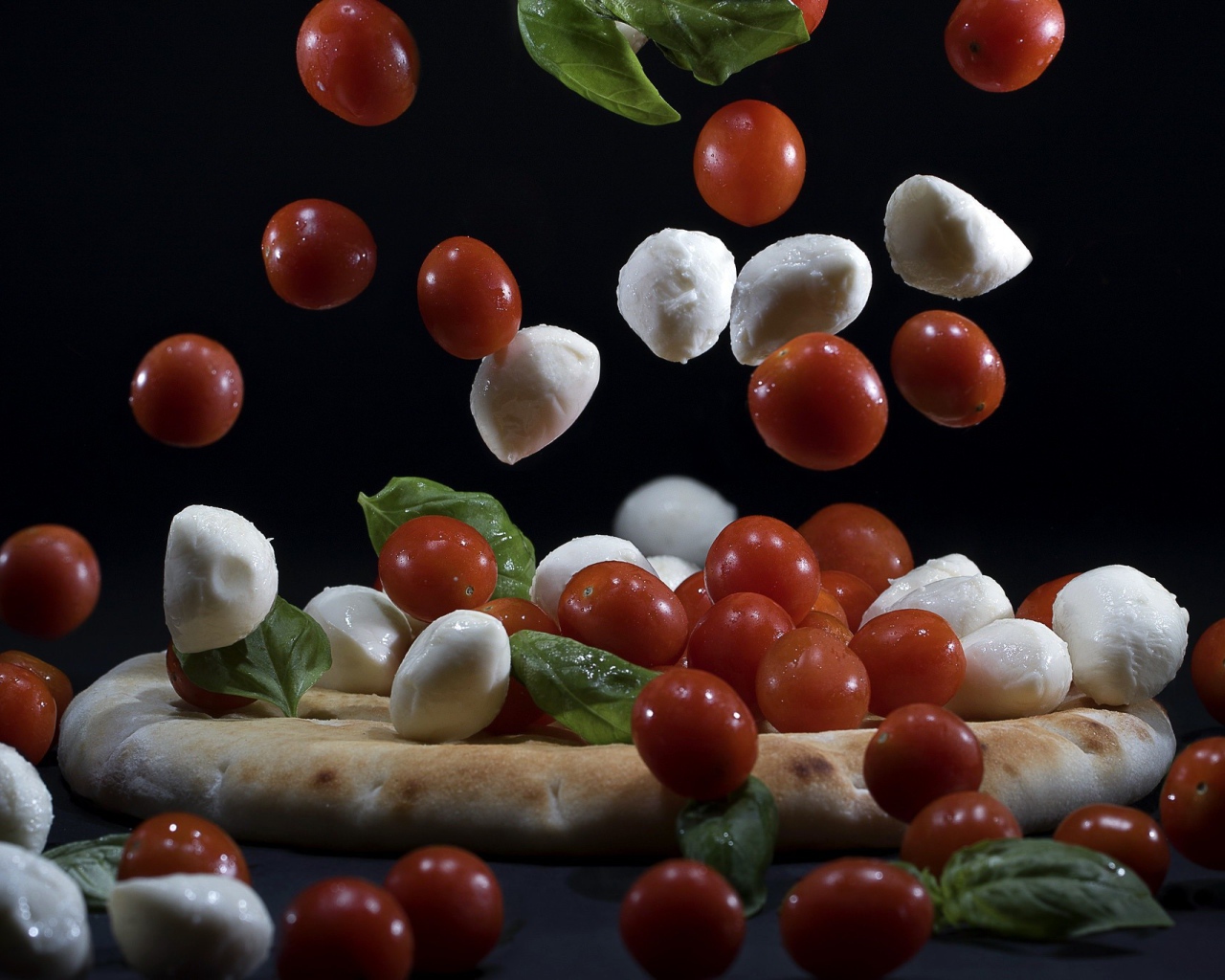 Помидоры и сыр Моцарелла падают на пиццу 