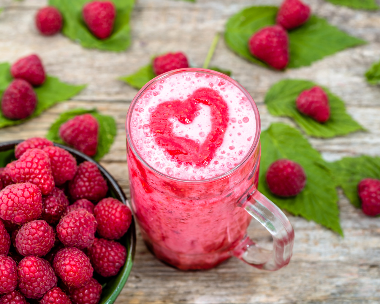 Бокал малинового коктейля со свежими ягодами малины