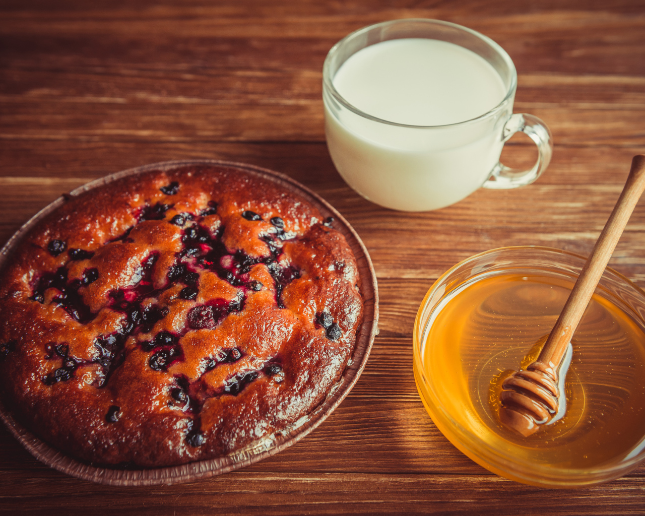 Пирог с ягодами, медом и молоком на столе