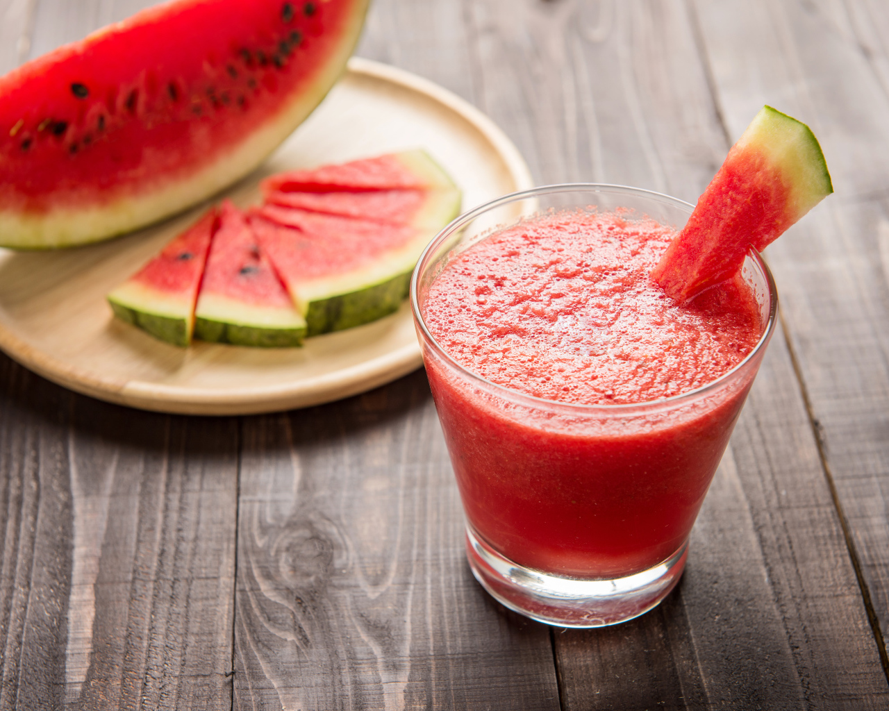 Арбузный смузи в стеклянном стакане с кусочками арбуза