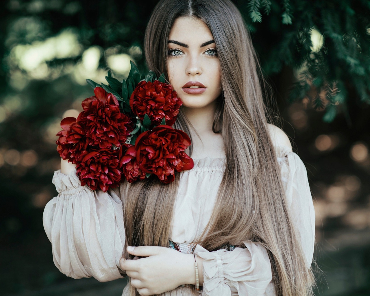 Молодая девушка с букетом бордовых пионов 