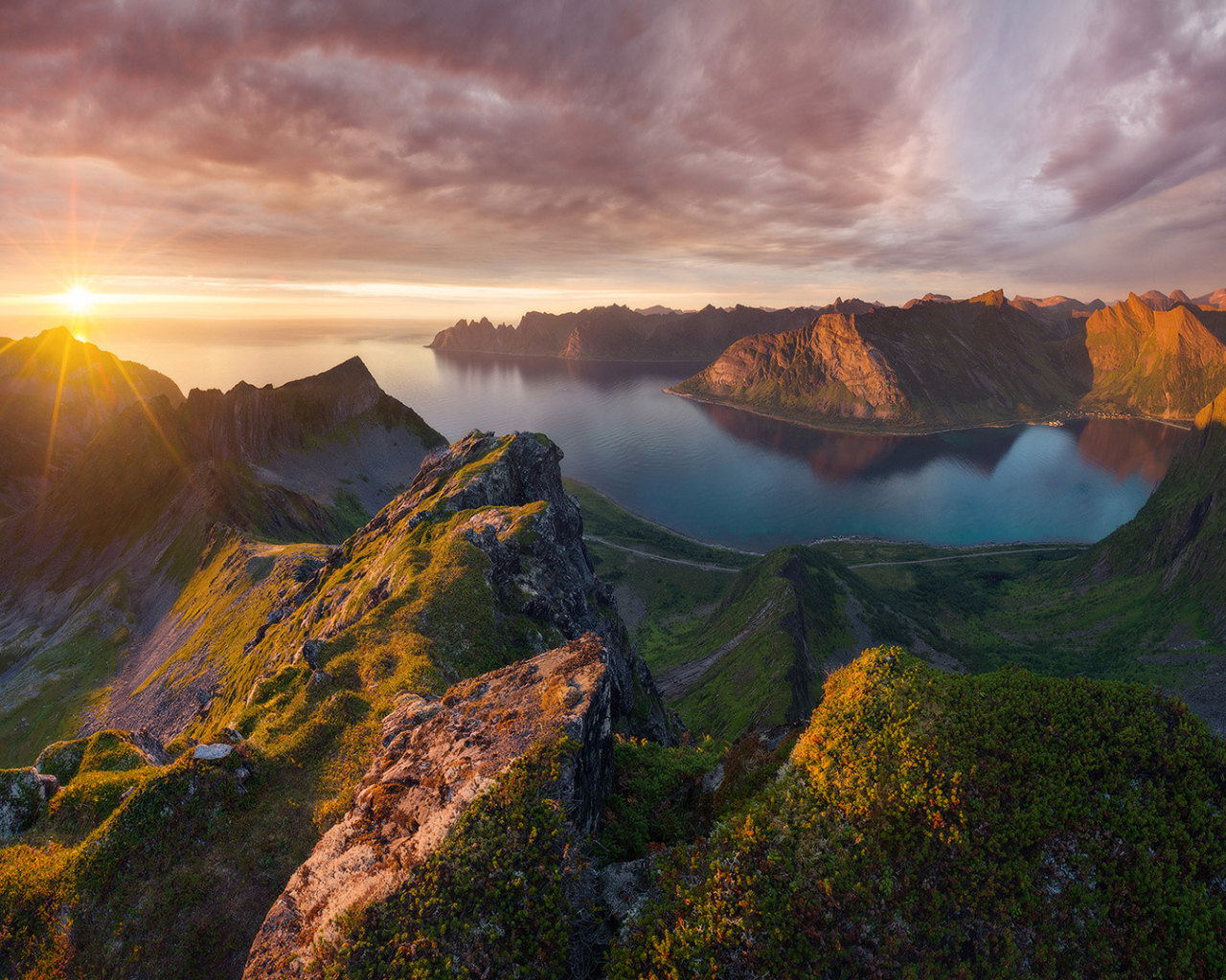 Восход солнца в красивом небе над покрытыми зеленью горами 