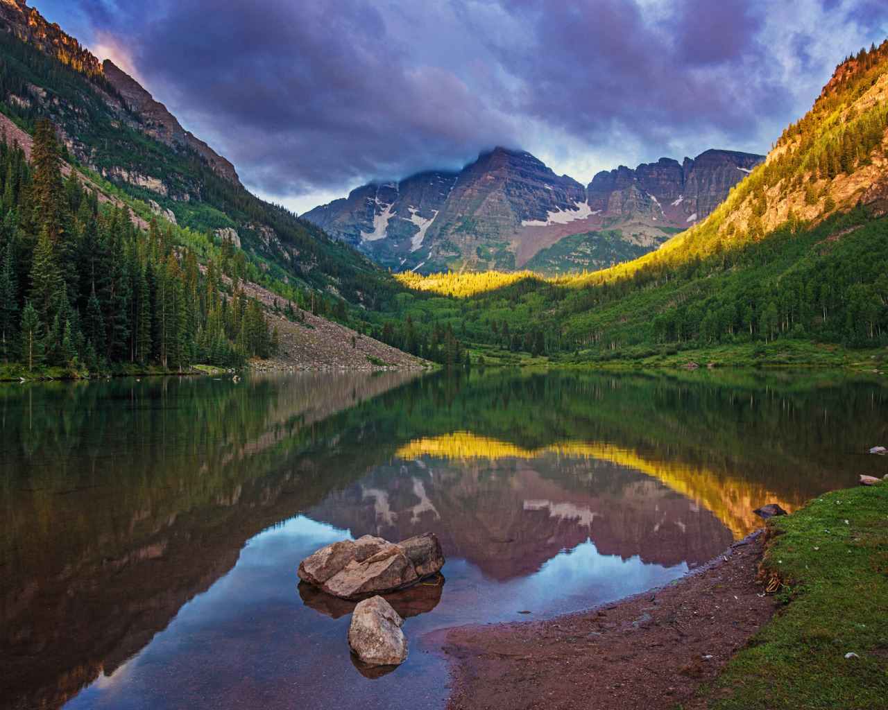 Покрытые зеленью горы отражаются в чистой воде озера