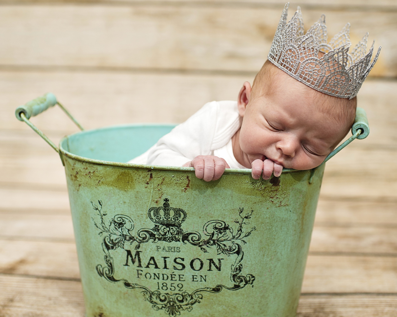 Спящий грудной ребенок с короной на голове