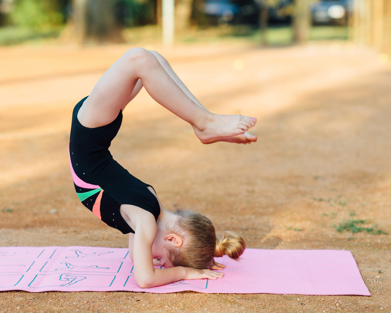 Маленькая девочка занимается гимнастикой