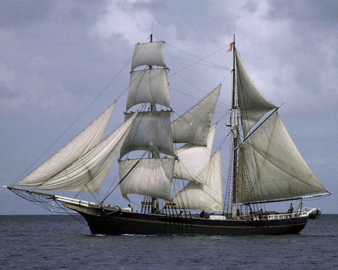 A ship with white sails in the sea
