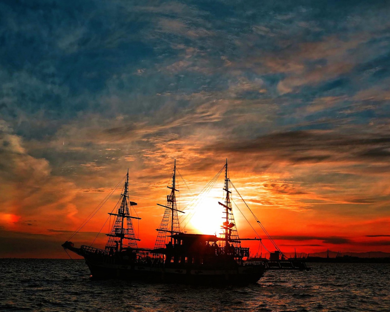 The ship in the rays of the setting sun 