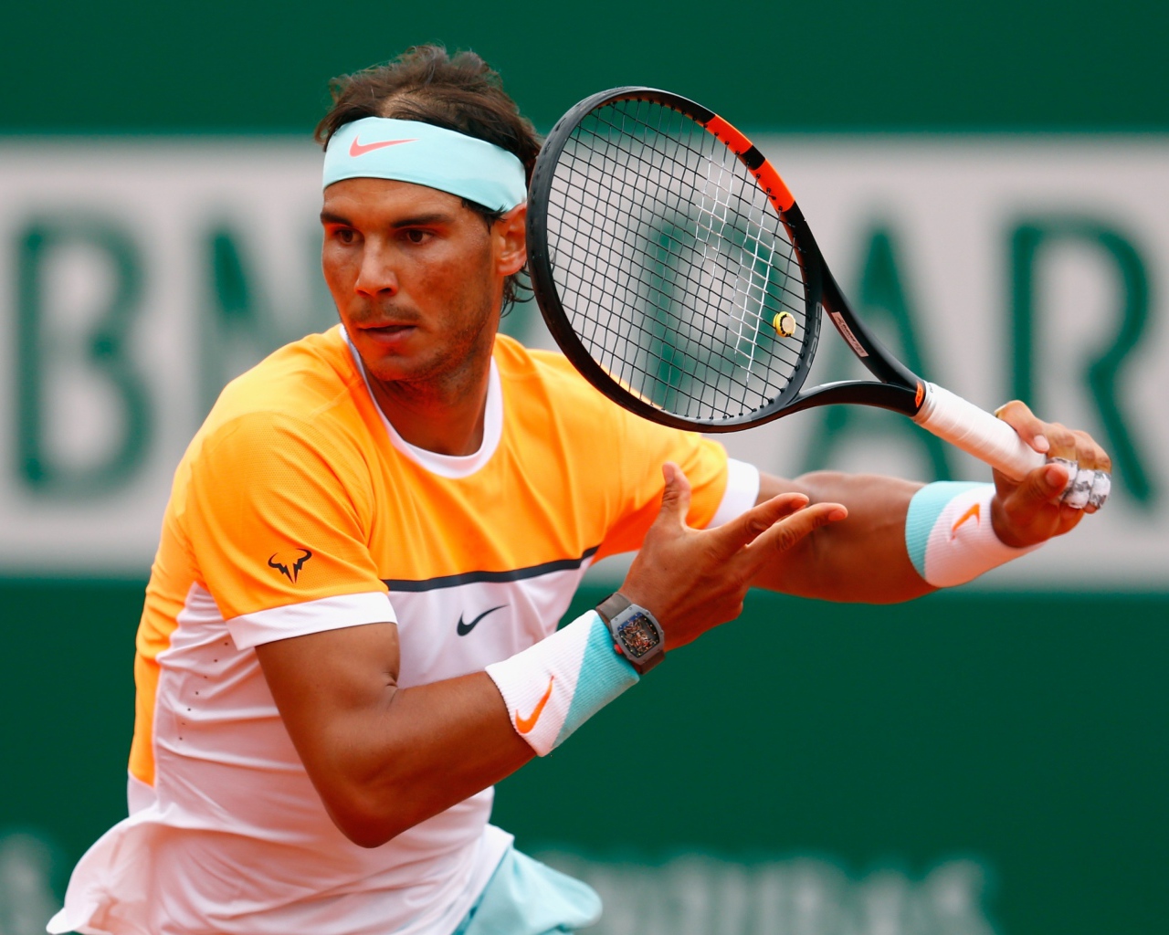 Теннисист Рафаэль Надаль с ракеткой на корте 