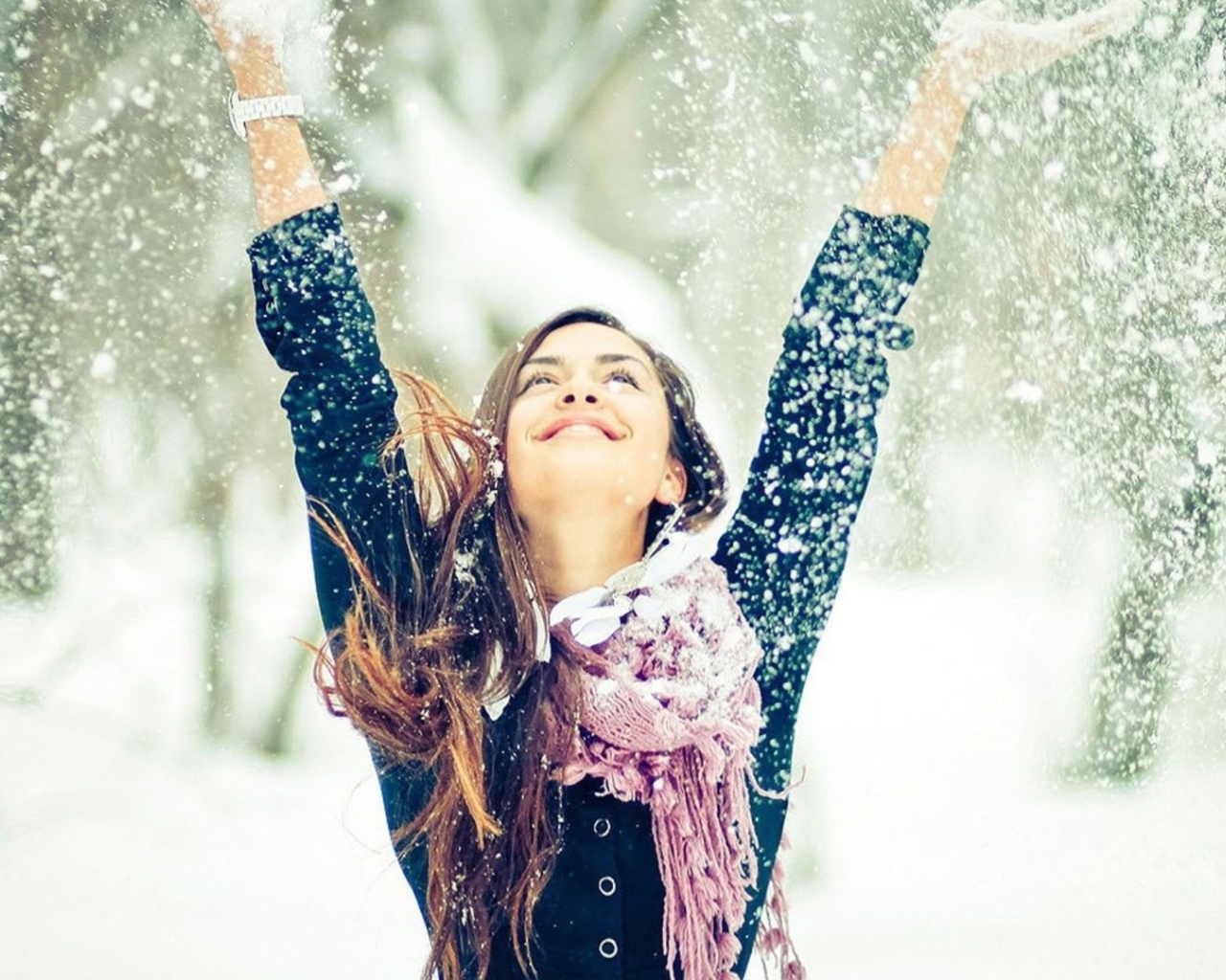 Beautiful girl enjoys snow