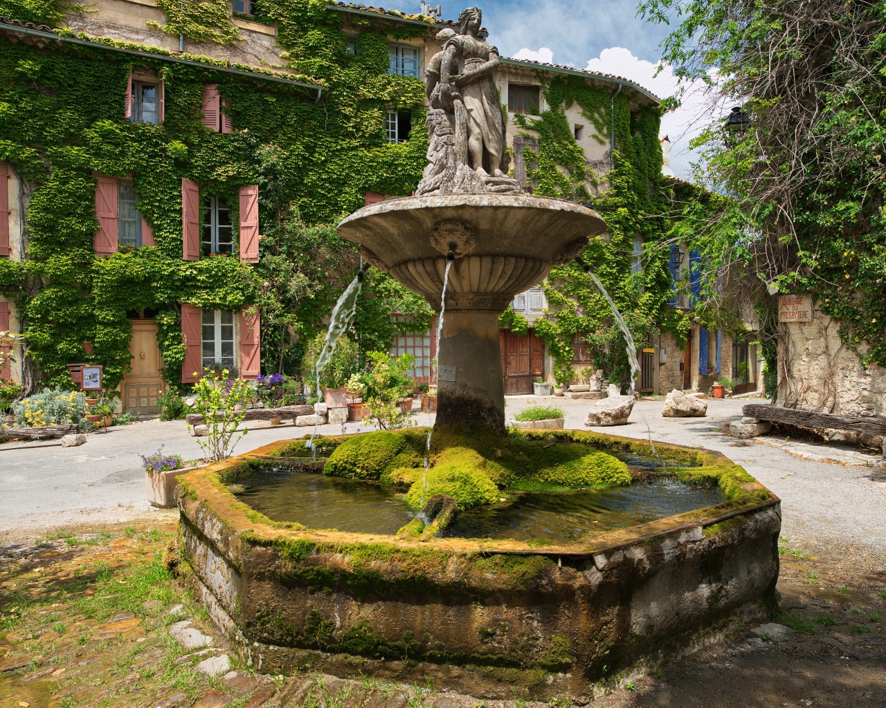Старинный покрытый мхом фонтан на площади Сеньон, Франция