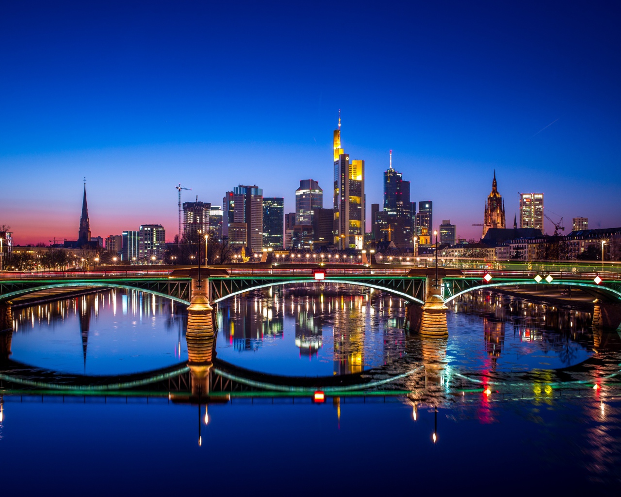 The night city of Frankfurt is reflected in the water, Germany