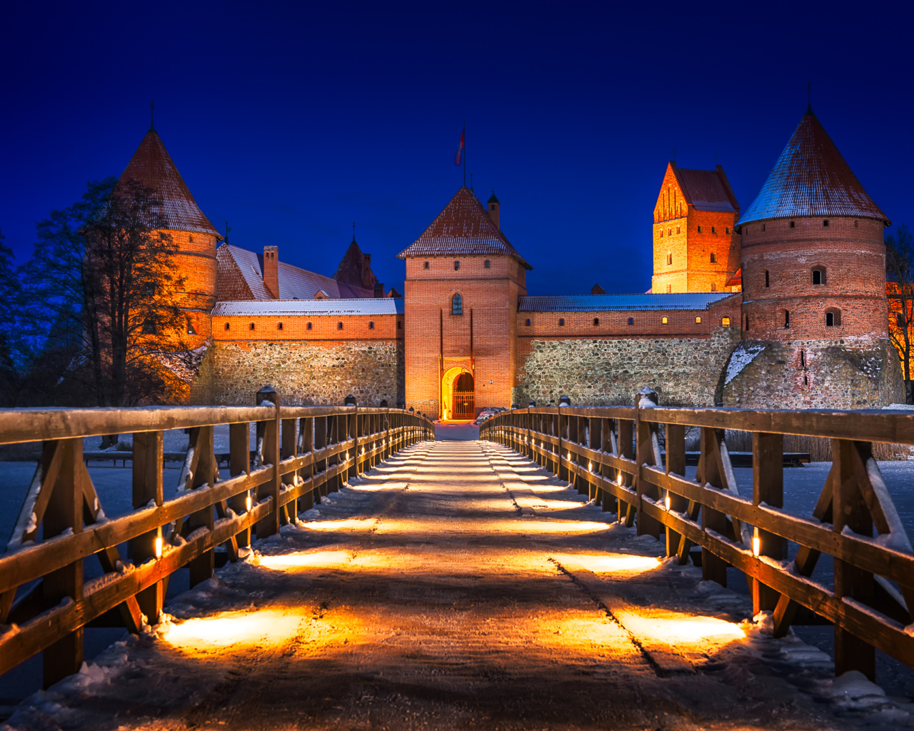 Bridge under the light of night lights to Trakai Castle, Lithuania