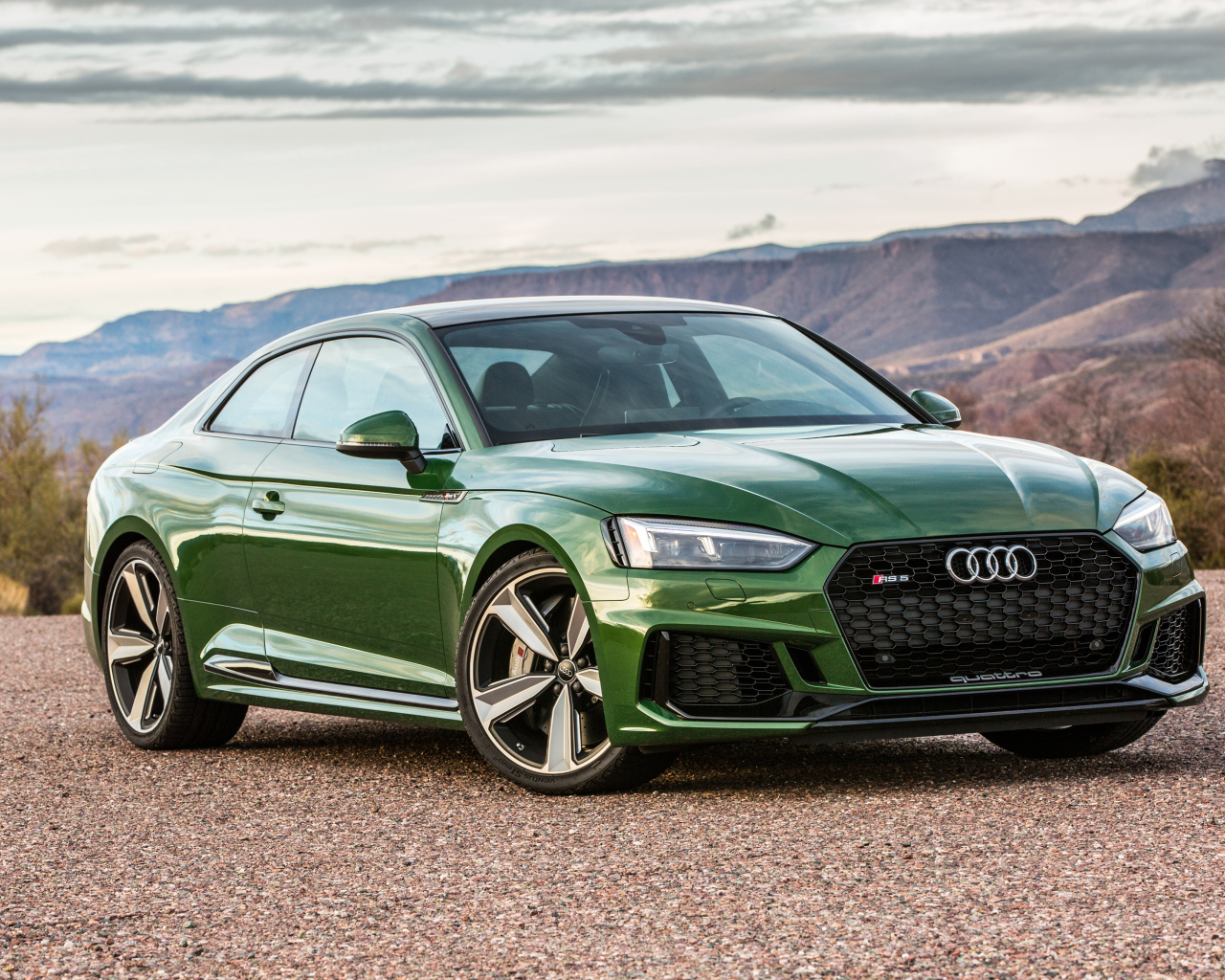 Green car Audi RS 5, 2018 on the background of the horizon