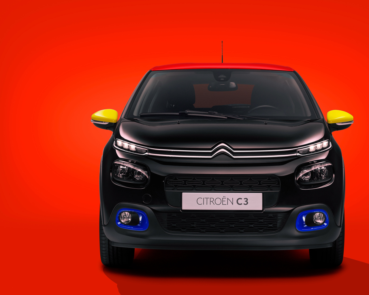 Черный автомобиль Citroen C3 JCC на красном фоне
