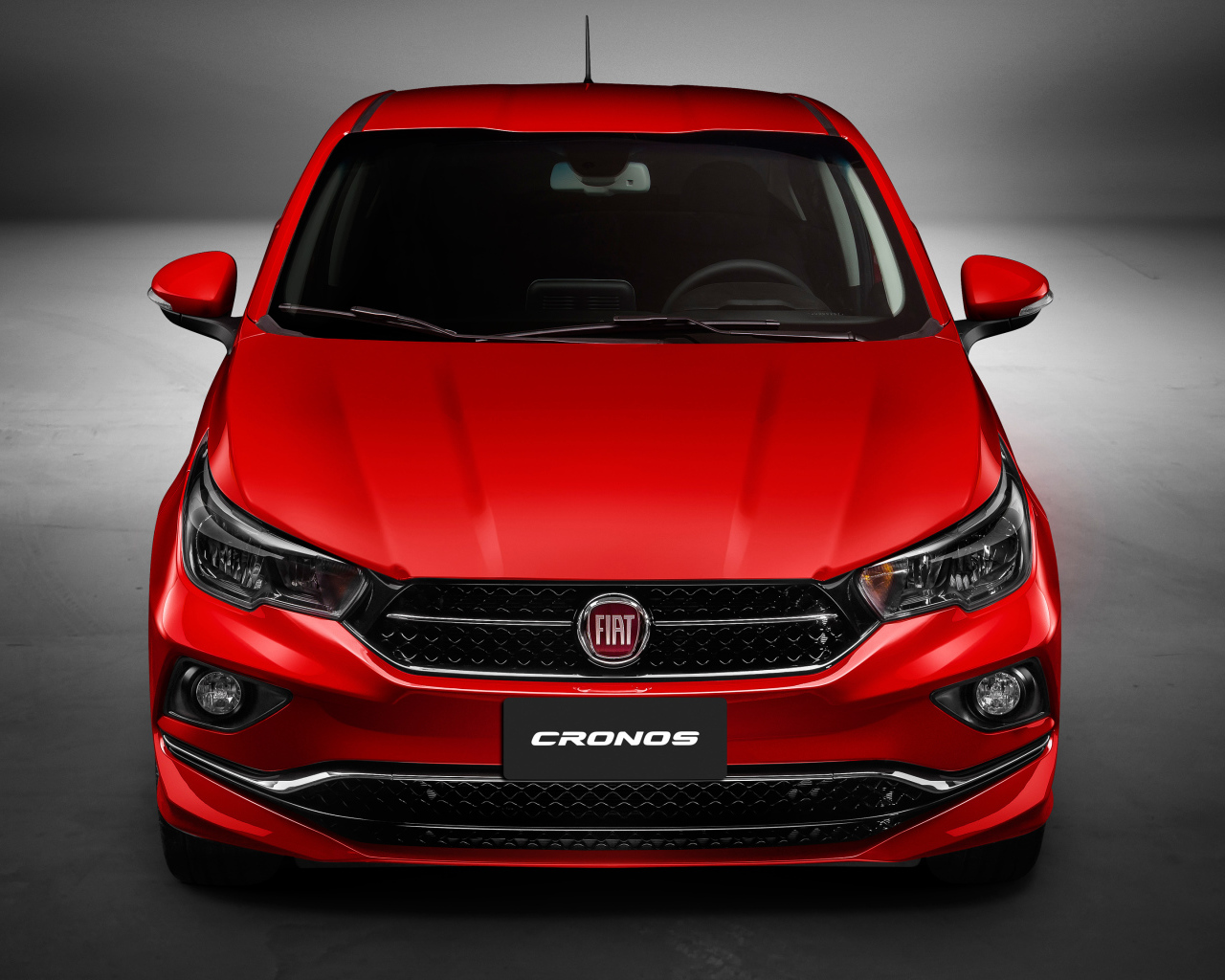 Красный автомобиль Fiat Cronos  2018 года, вид спереди