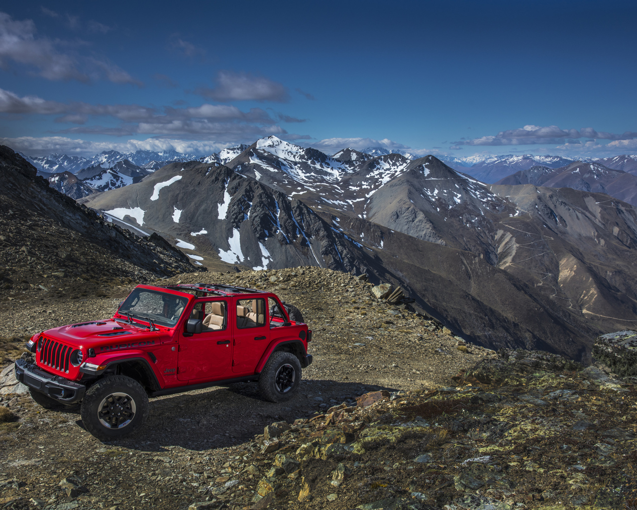 Red Jeep Wrangler in the mountains