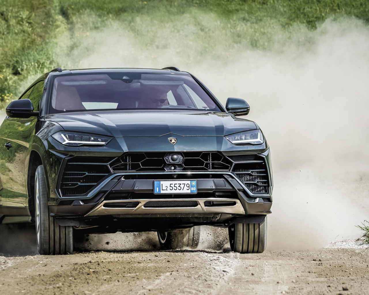 SUV Lamborghini Urus 2018 on the road in the dust