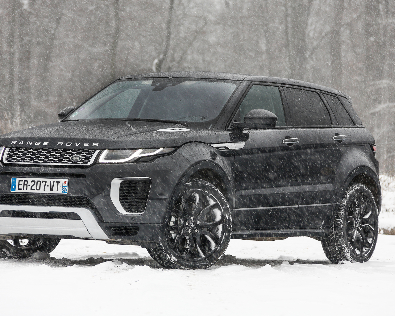 Черный внедорожник Range Rover Evoque Autobiography Si4 на заснеженной дороге