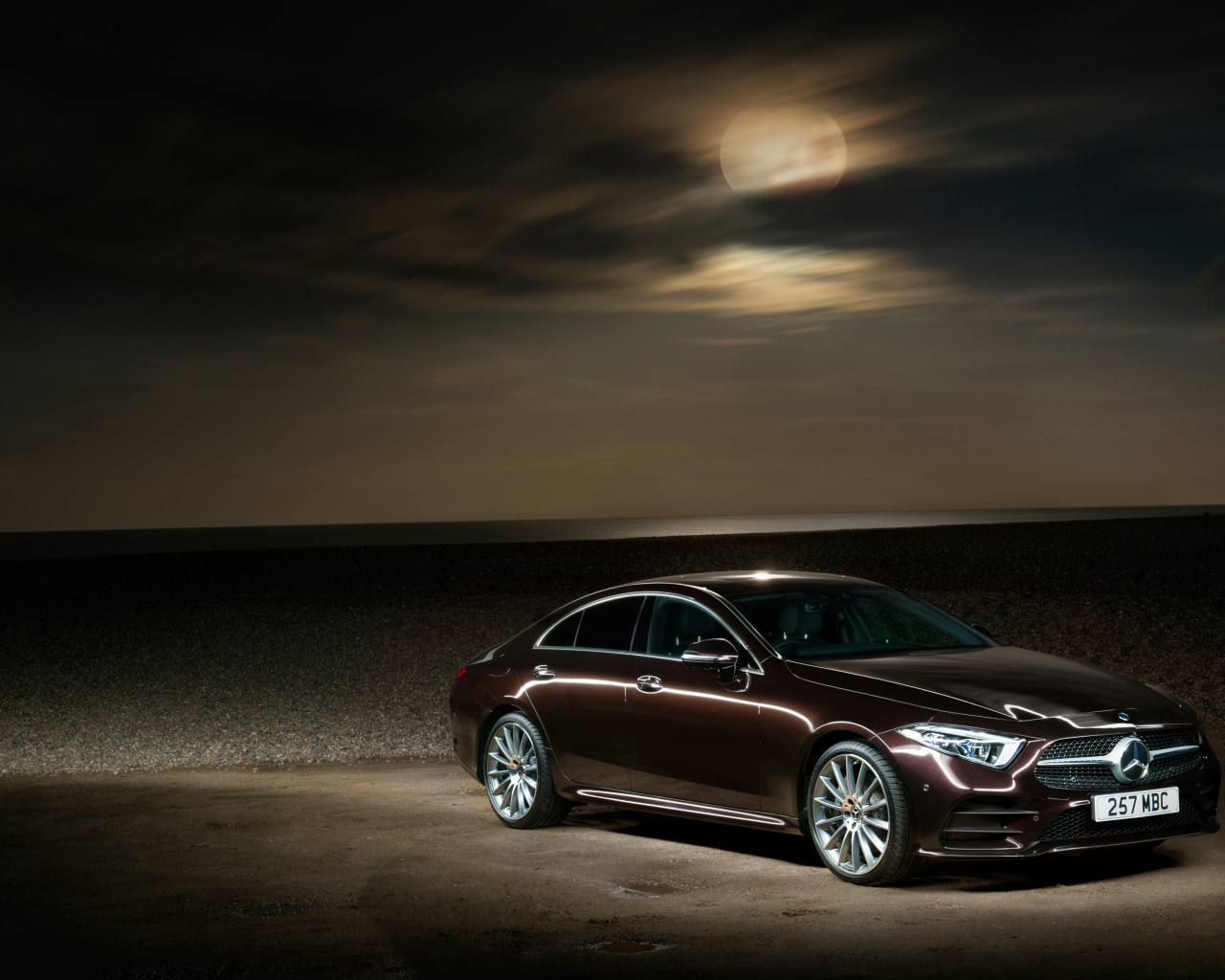Brown Mercedes Benz CLS 400 D AMG 2018 in the background of the moon