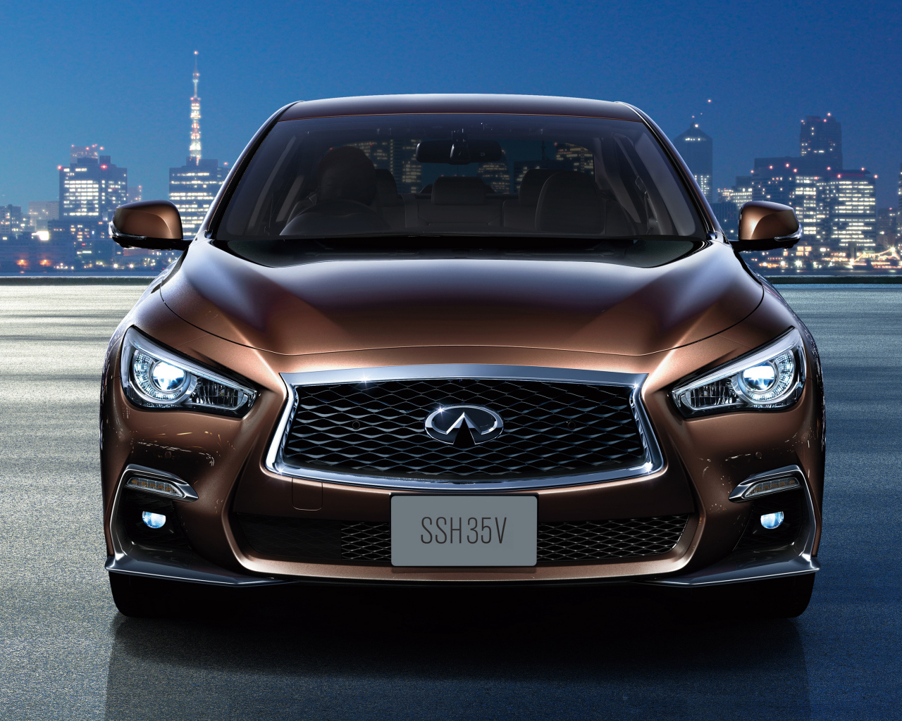 Коричневый автомобиль Nissan Skyline Hybrid, 2018 на фоне ночного города