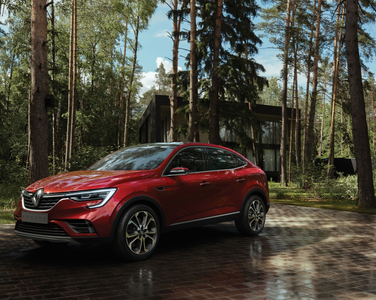 Красный стильный внедорожник Renault Arkana, 2018 года в лесу