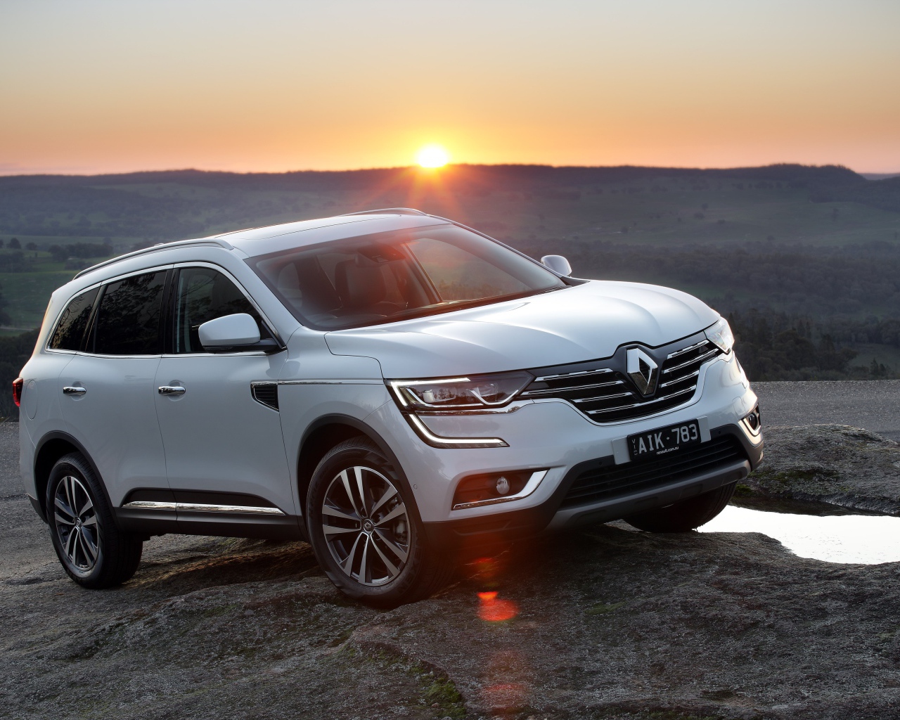 Белый внедорожник Renault Koleos, 2017 на фоне заката