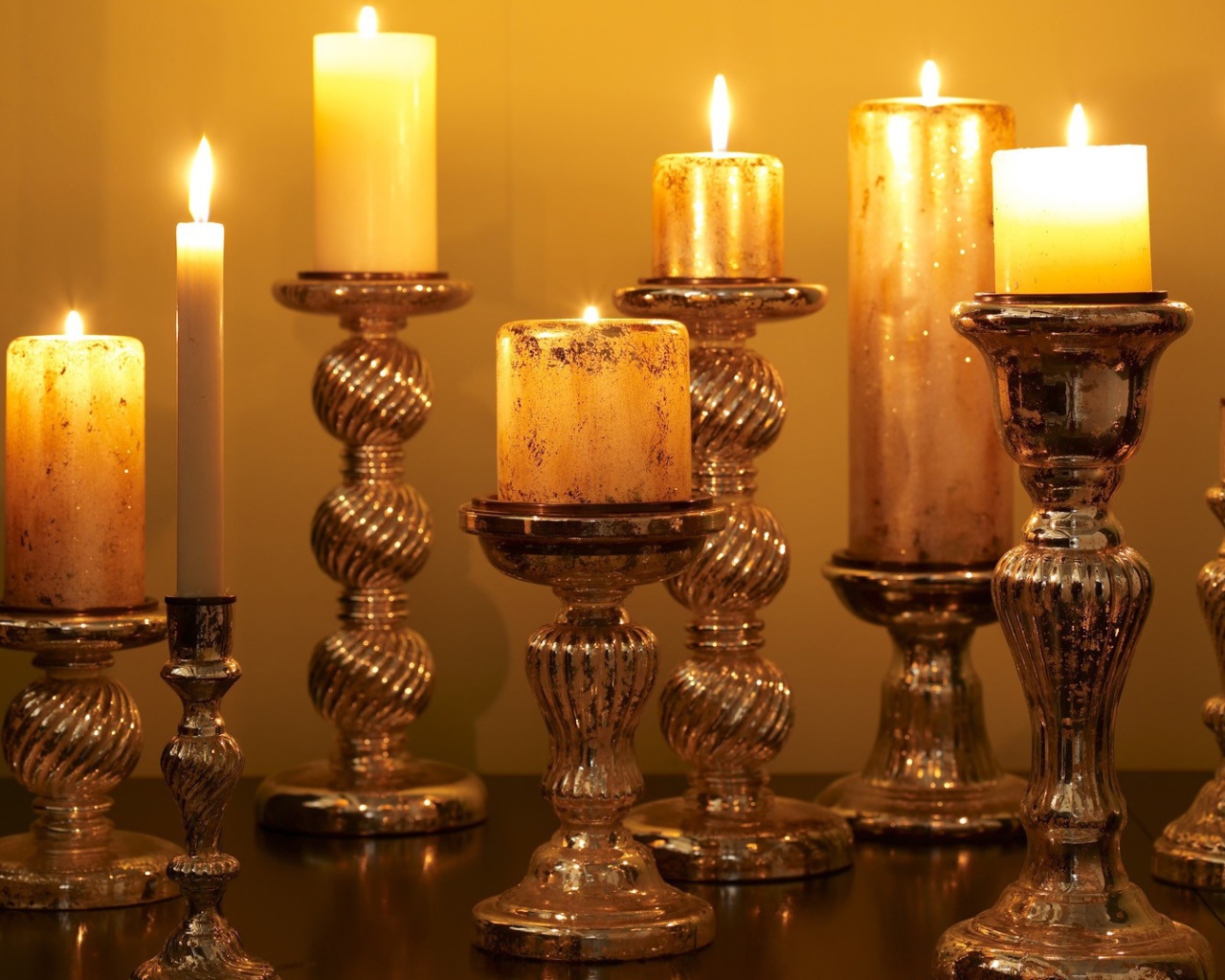Старинные подсвечники с зажженными свечами на столе 