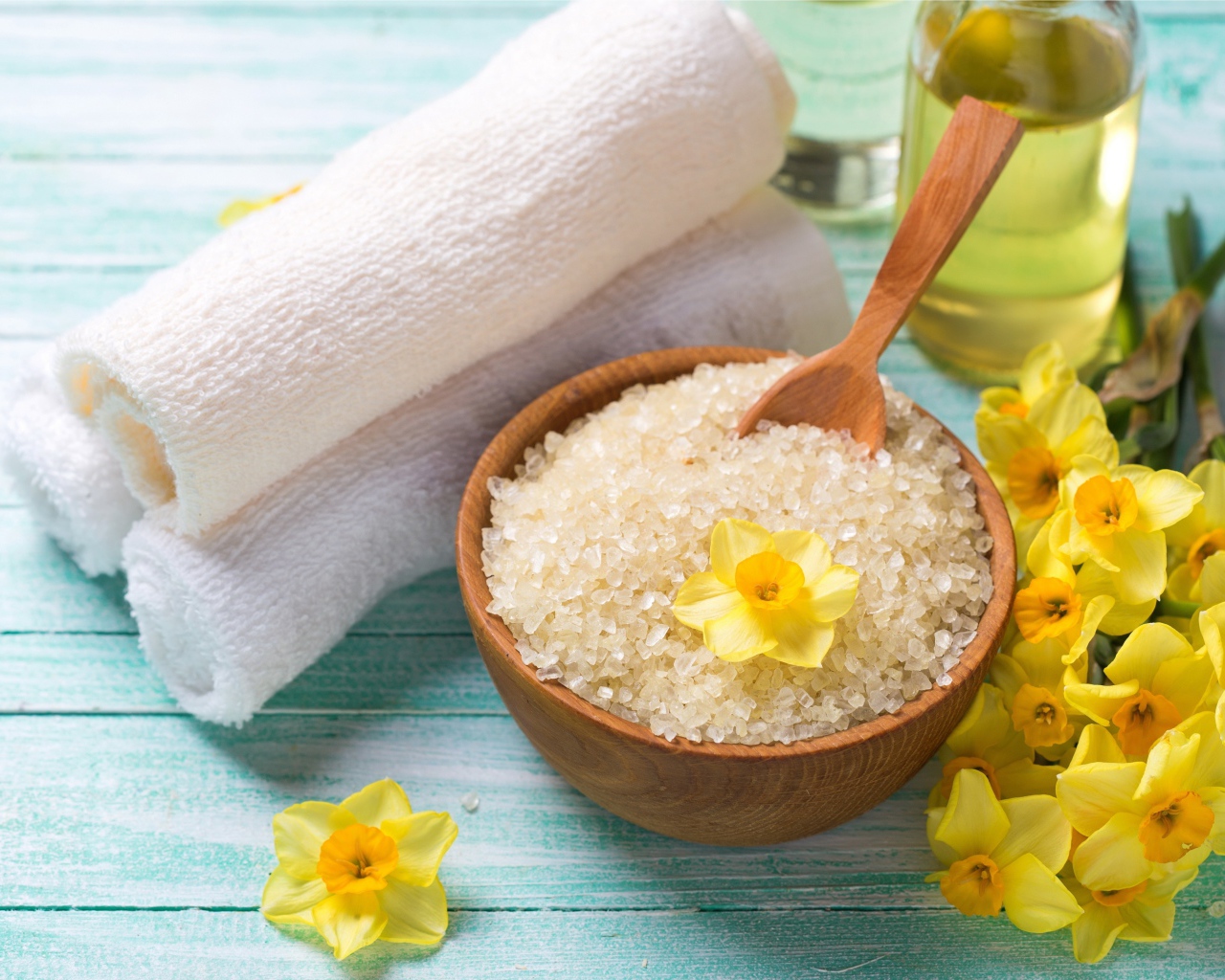 Соль с цветами нарцисса и полотенцем на столе