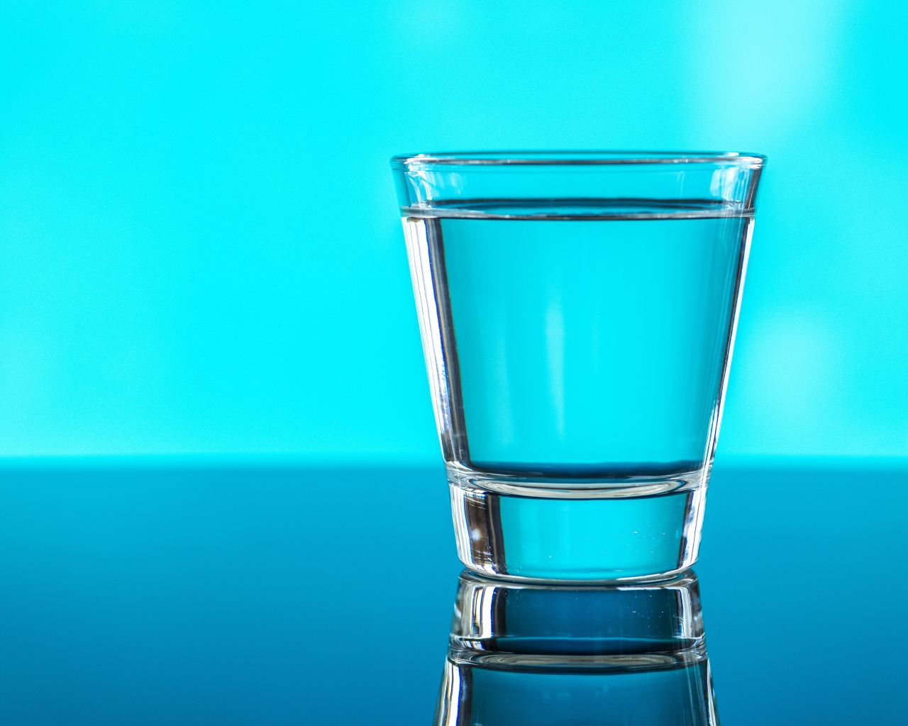 A glass of water on a blue background
