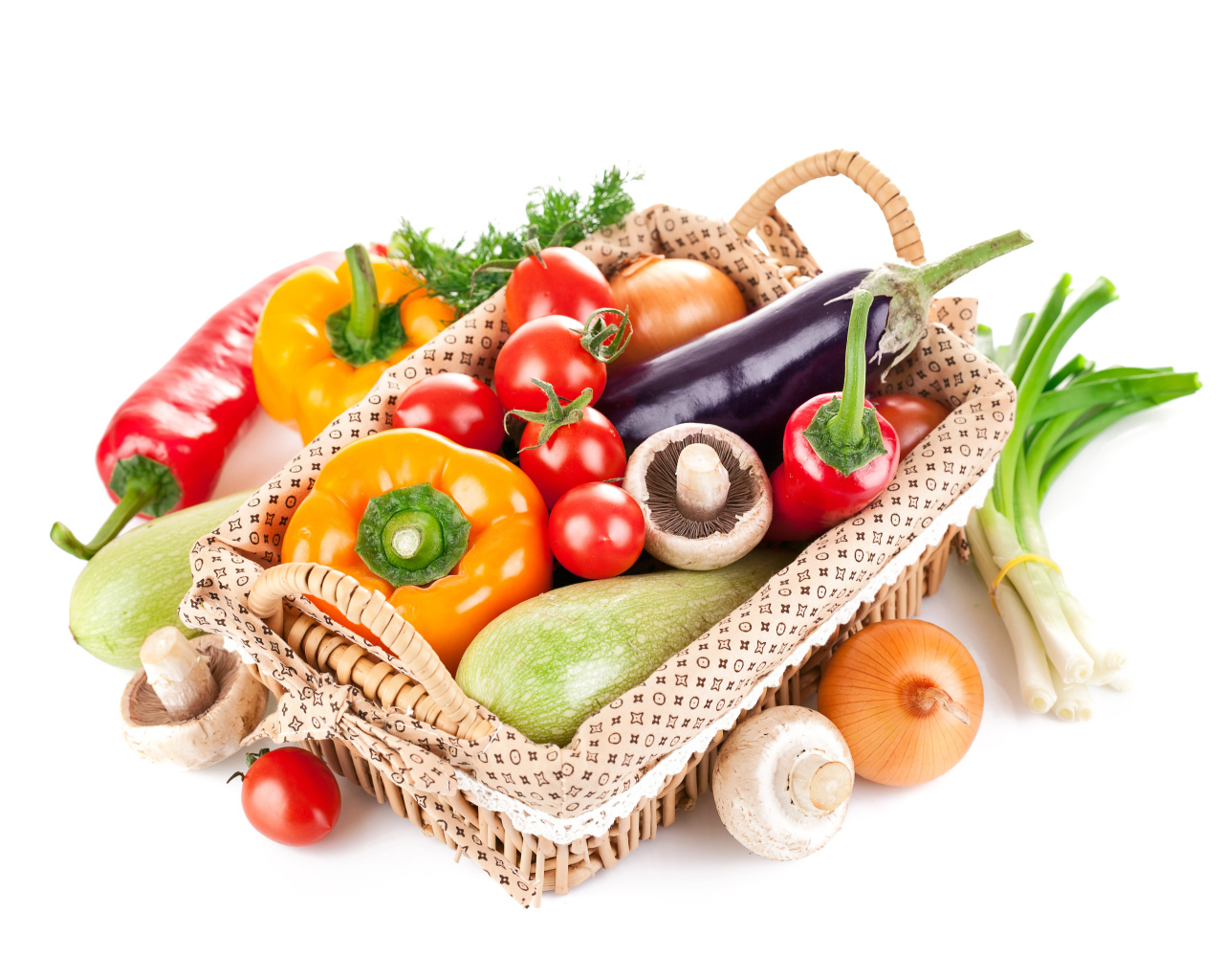 Fresh vegetables in a basket on a white background