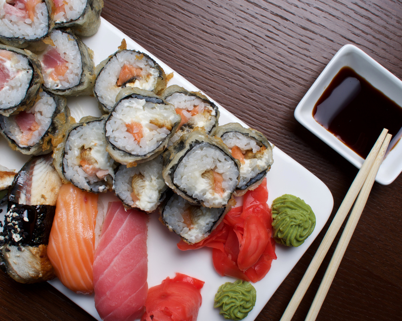 Горячие роллы с рыбой на столе с соевым соусом 