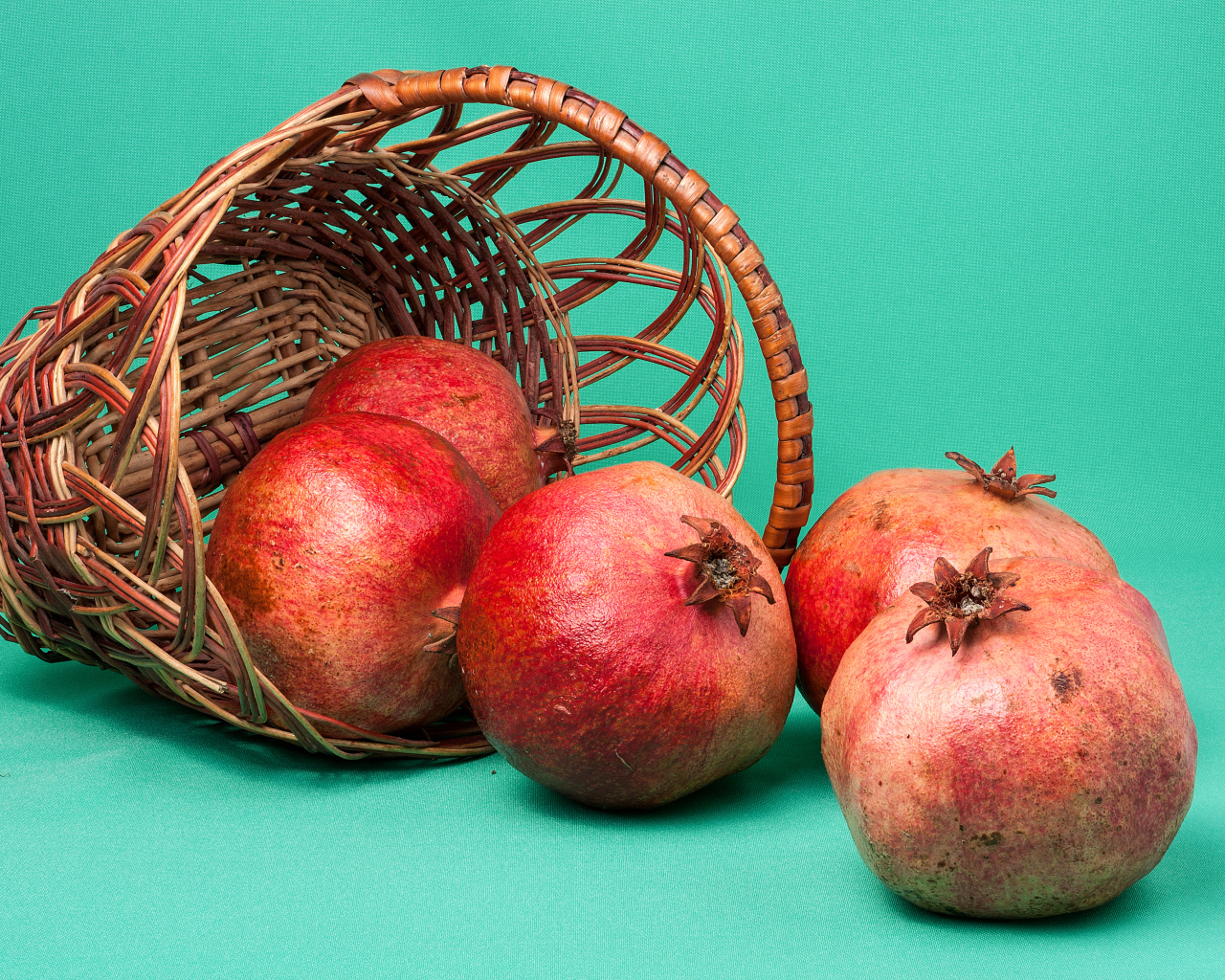 Плоды граната в корзине на голубом фоне
