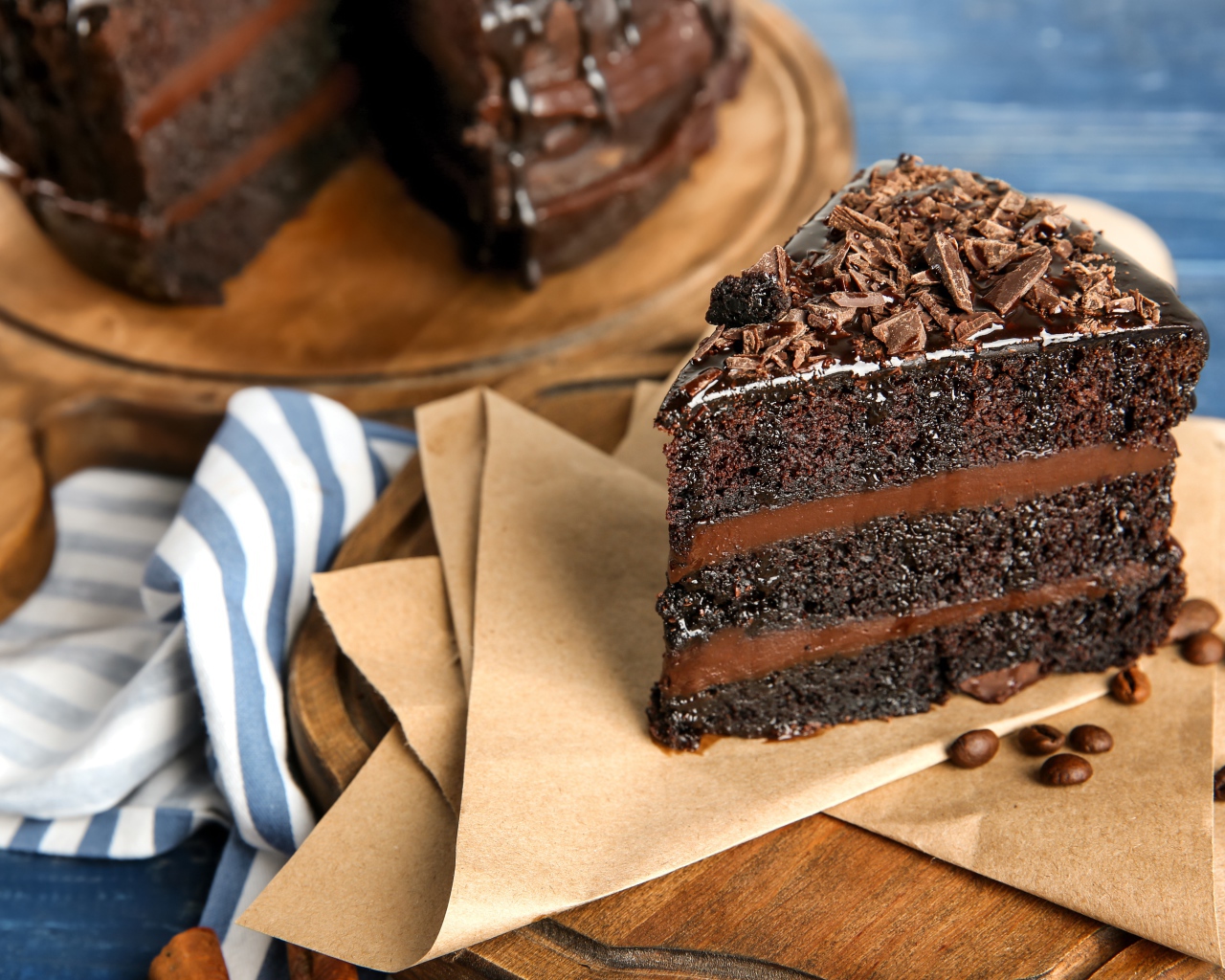 Кусок вкусного шоколадного торта на столе с кофейными зернами