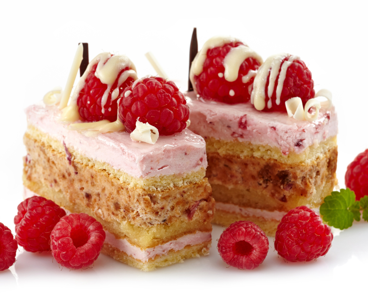 Пирожные с ягодами малины на белом фоне