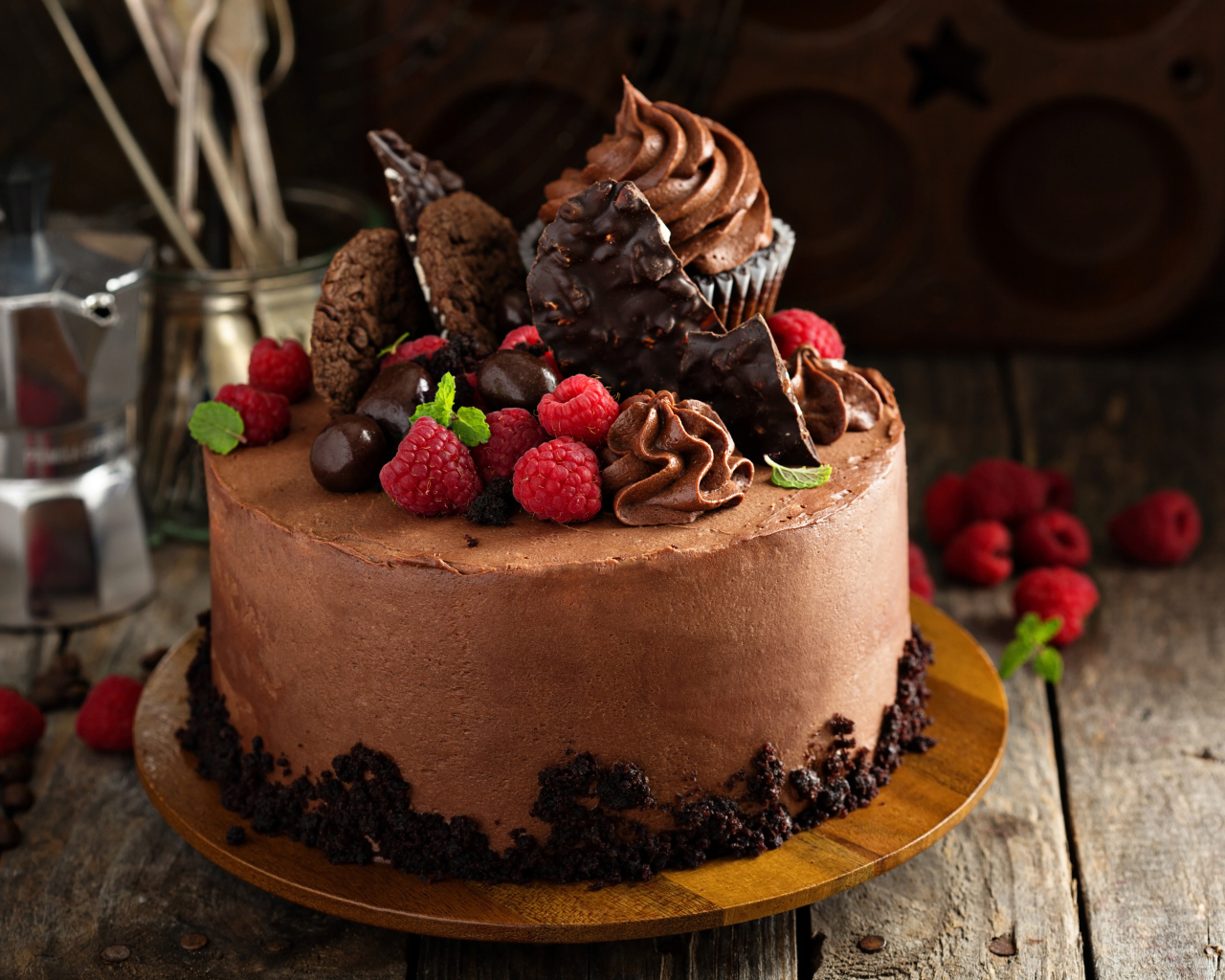 Шоколадный торт со сладостями и ягодами малины