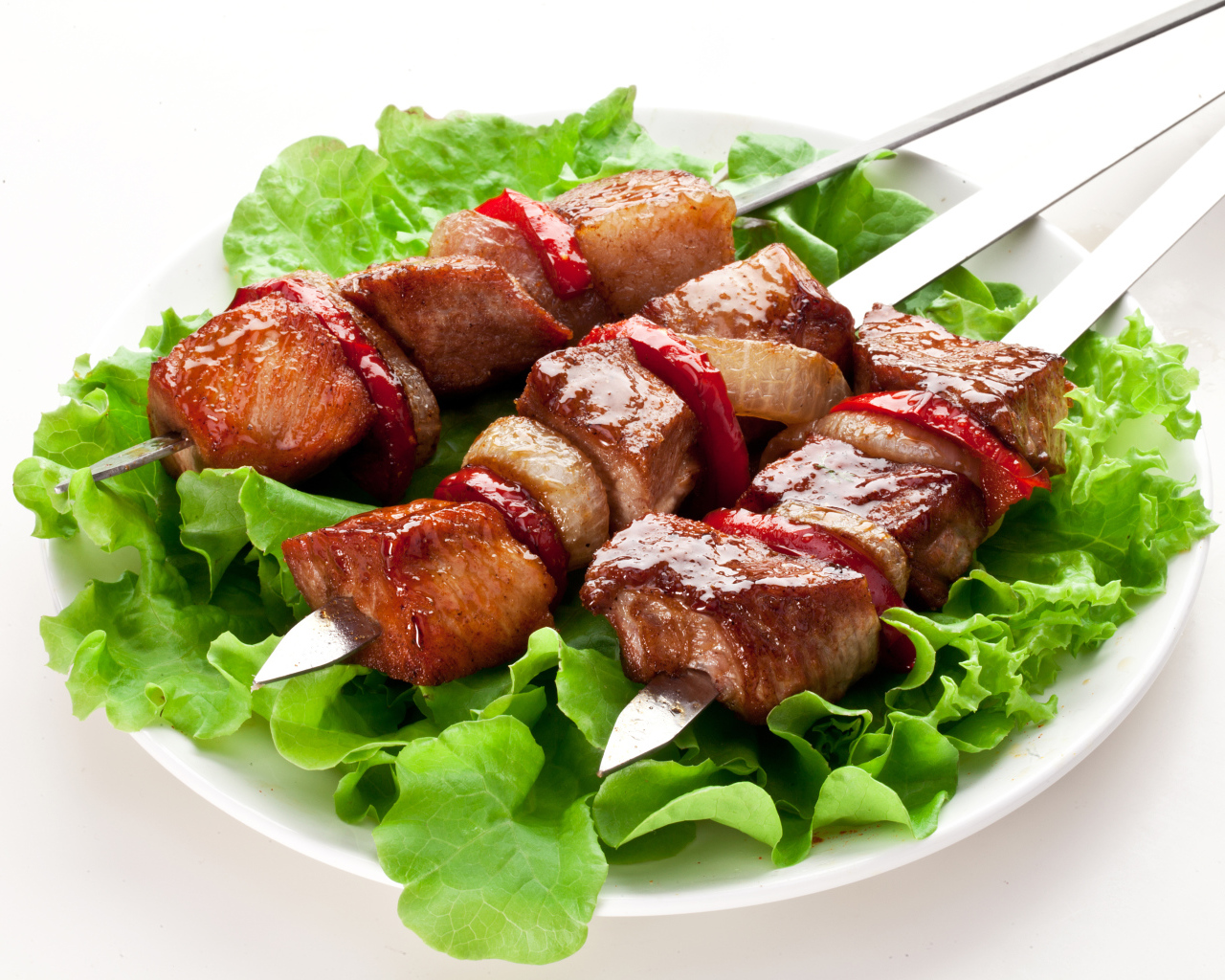 Аппетитный шашлык с листьями салата на шампурах 