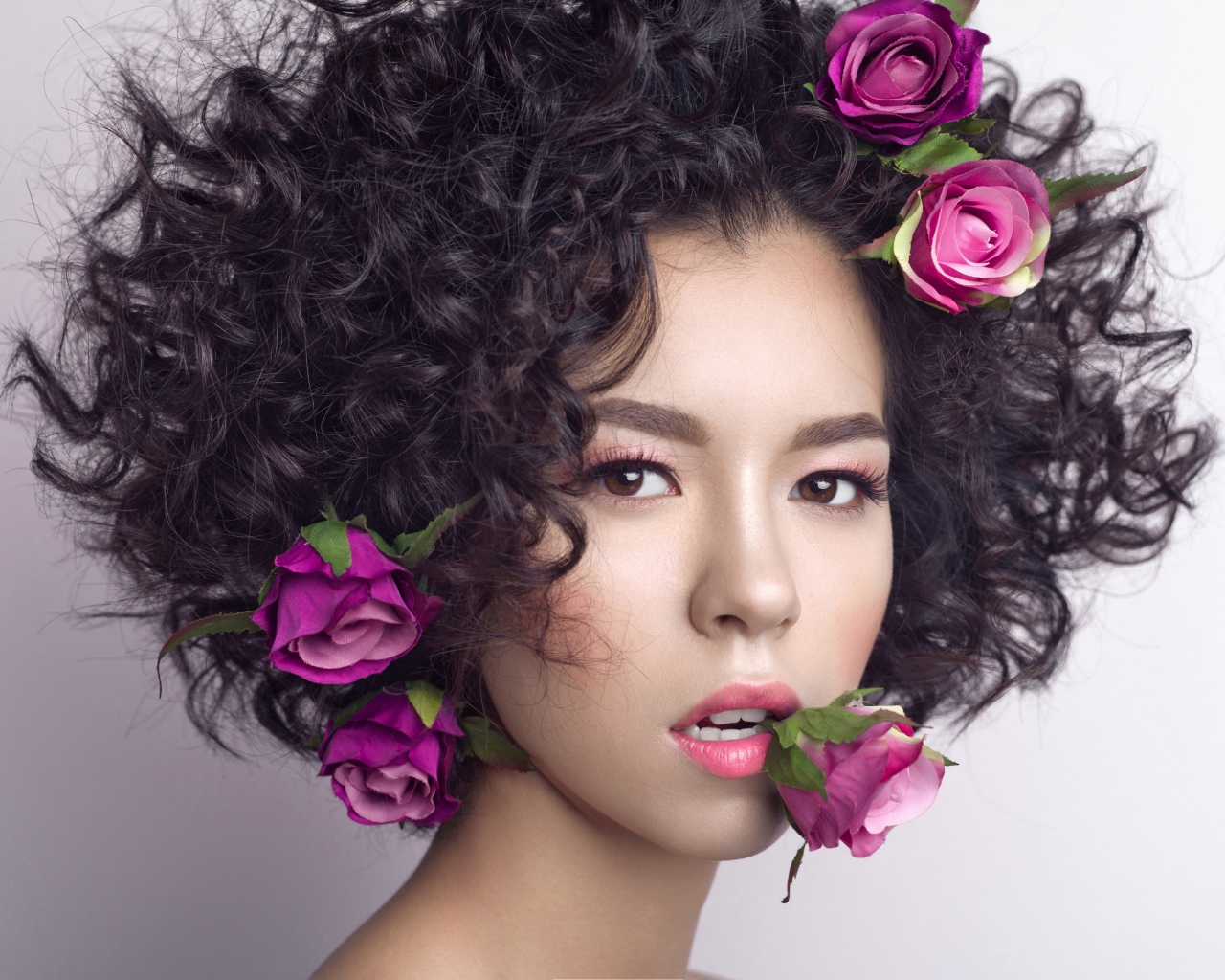 Молодая девушка с кудрявыми волосами с розами