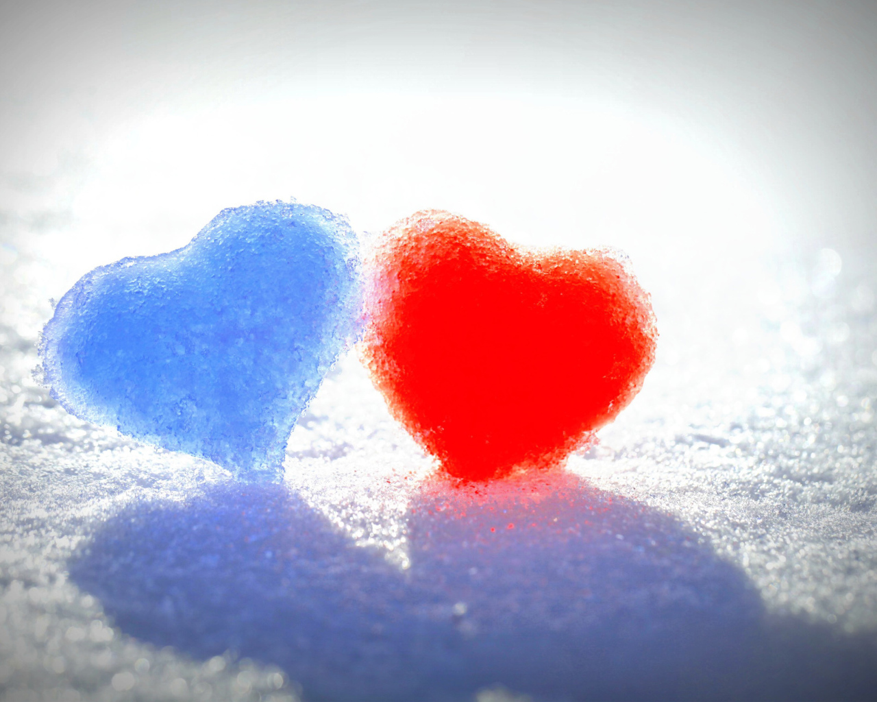 Голубое и красное сердце на белом снегу 