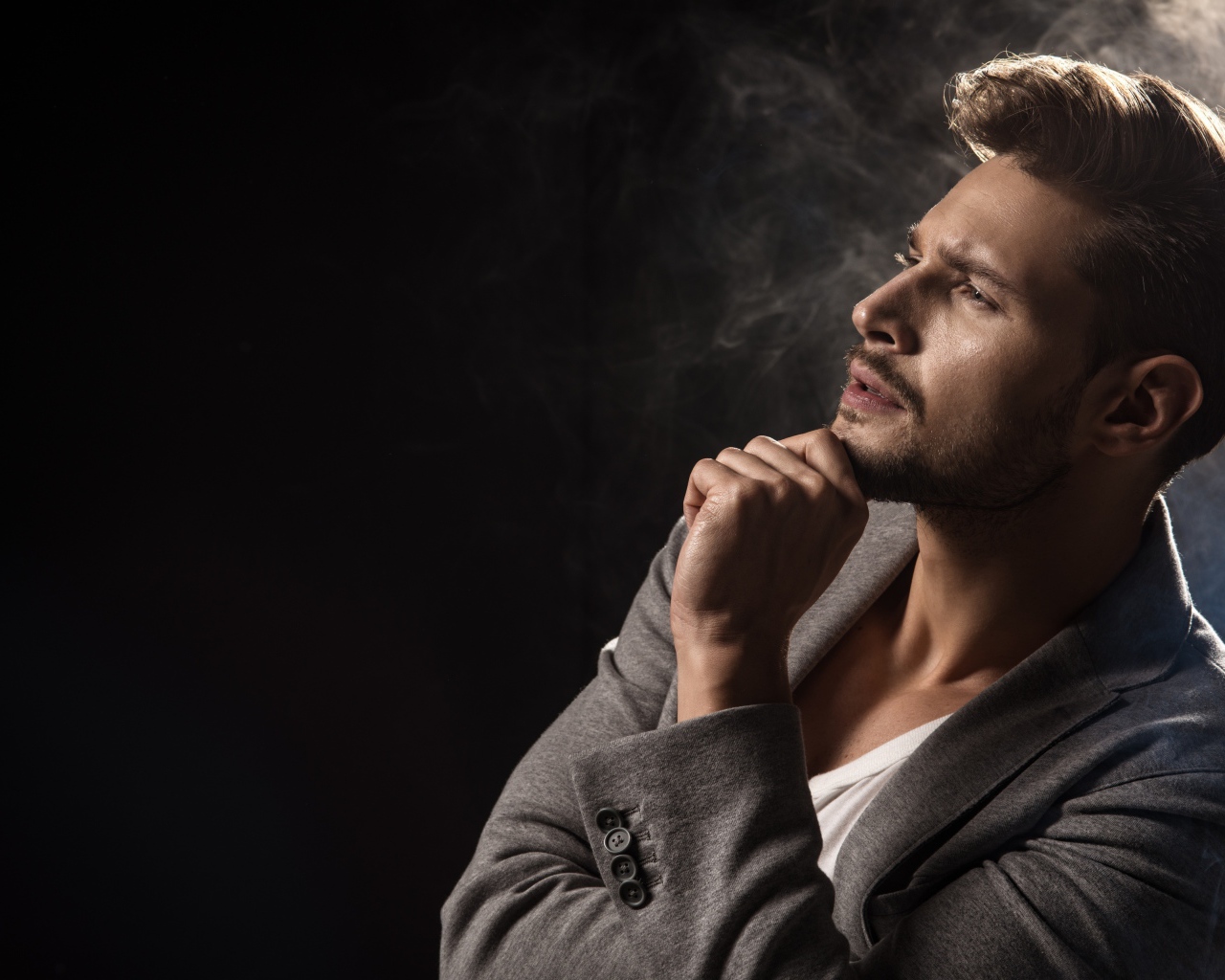 Красивый задумчивый мужчина в сером пиджаке