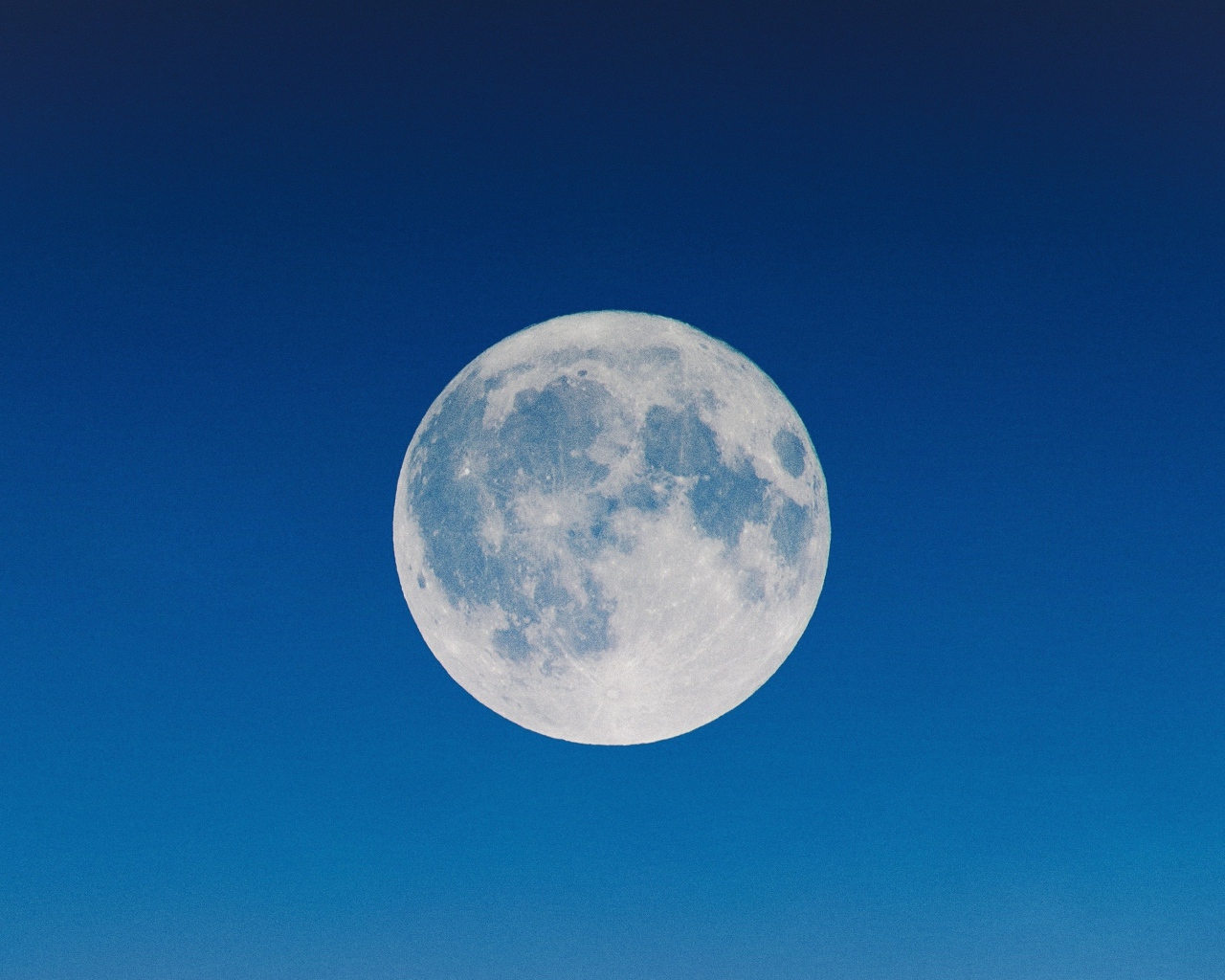 Big white moon in a blue sky