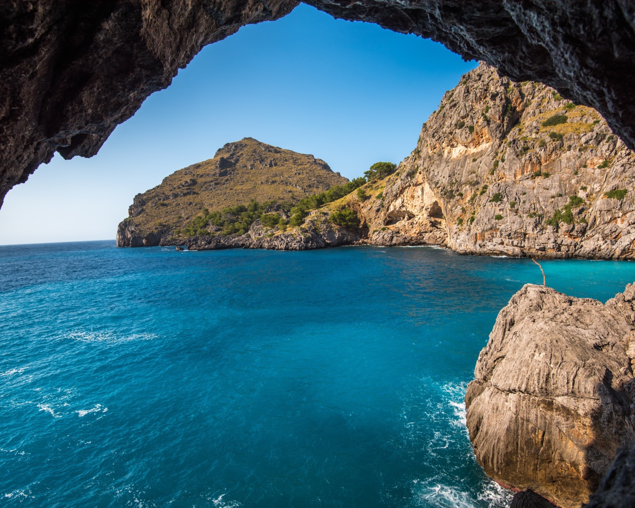 Скалы в морском заливе под голубым небом