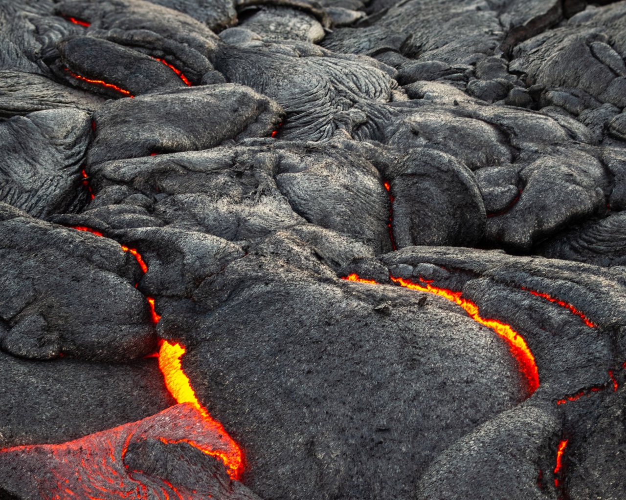 Lava makes its way through the cracks in the volcano