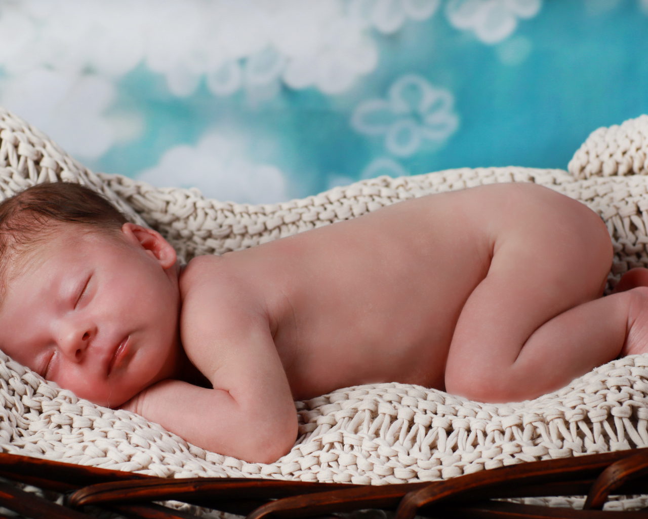 Маленький спящий грудной ребенок в колыбели